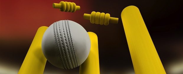indoor cricket: white cricket ball hits yellow stumps
