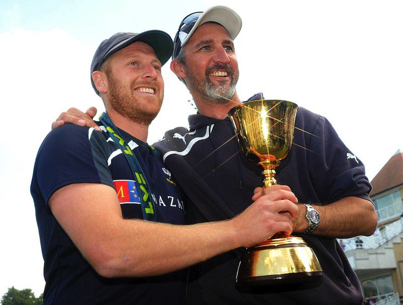 jason gillespie and andrew gale hold the championship trophy