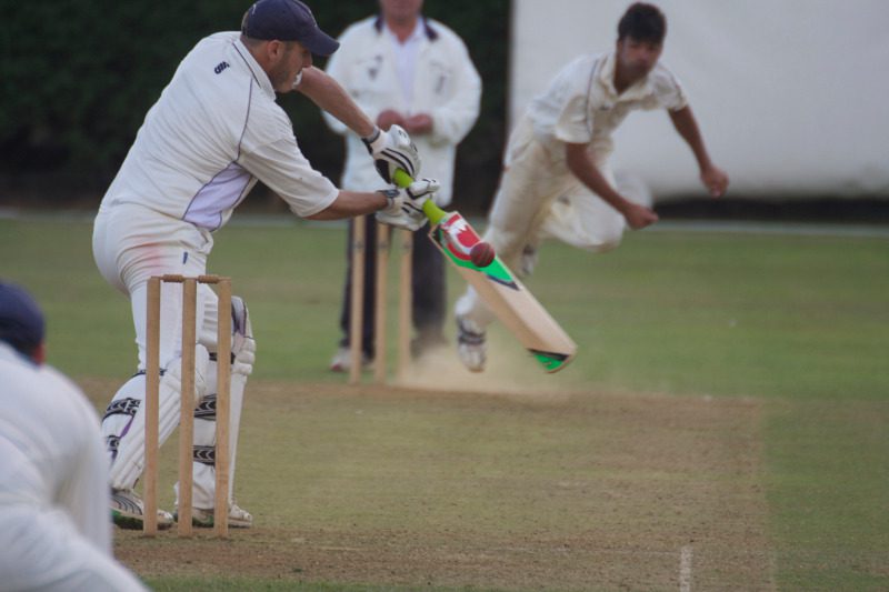 club cricket bowler beats the bat