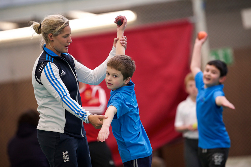 Katherine Brunt offers bowling coaching to a junior cricketer as part of the Drax Cup