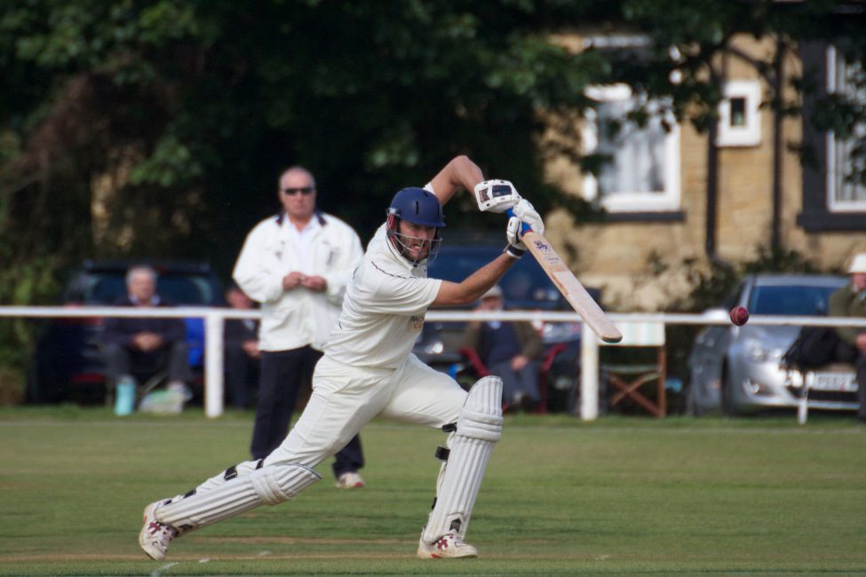 Club cricket - cricketer drives the ball