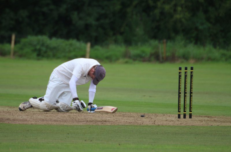 a batsman on his knees after a runout