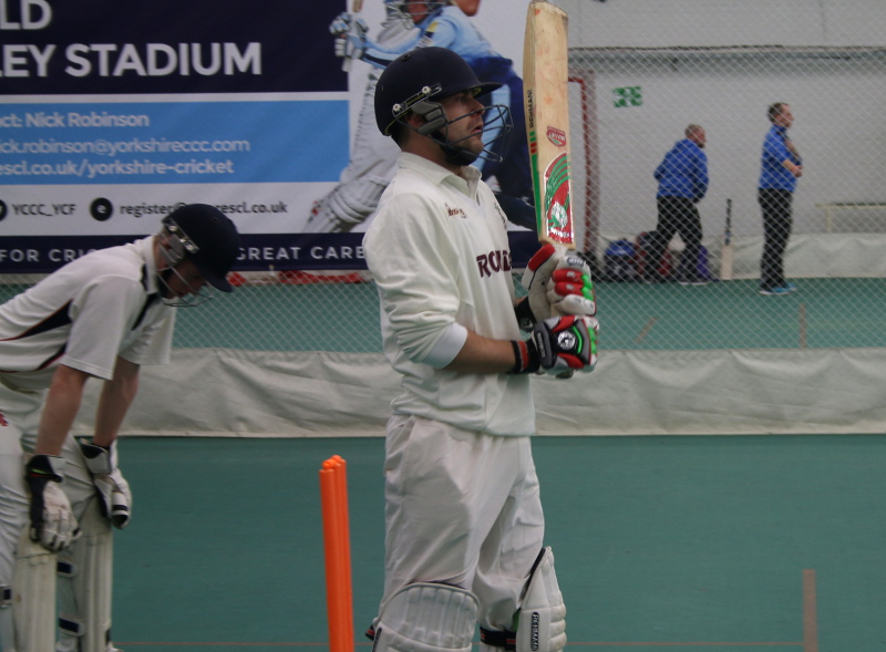 tim jackson (woodlands cricket club) waits between balls as he bats indoors