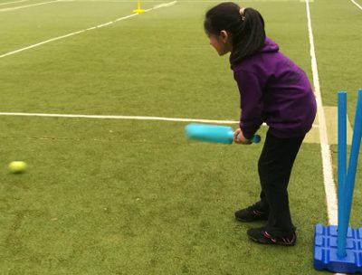 a girl bats at Keighley BME Development Centre