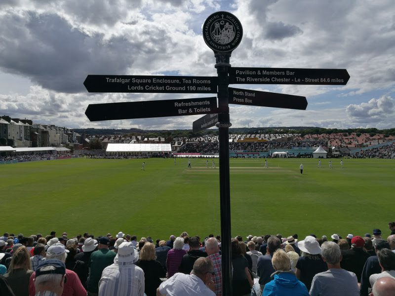 scarborough cricket club pitch view from the entrance with the famous black signpost