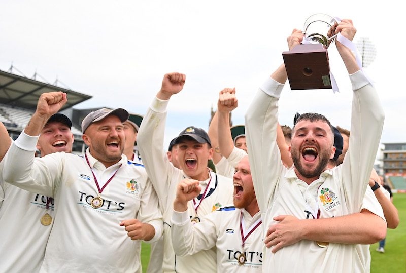 Cleve Cricket Club players in whites from Serious Cricket celebrate with trophy