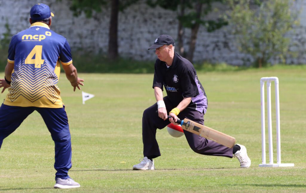 John Garbett of Yorkshire Vikings VICC plays a forward drive as a Bradford VICC fielder is nearby.